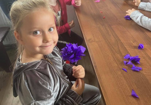 Dzieci robią kwiaty z bibuły.