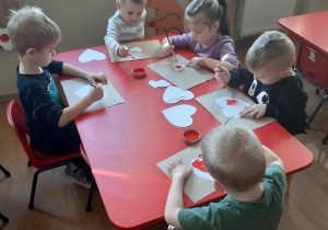 Motylki malują serduszka do ozdobienia foto- budki.