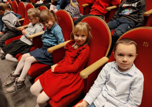 Dzieic siedzą w teatrze podczas przerwy w spektaklu