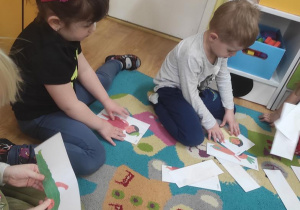 Dzieci układają puzzle z owoców i warzyw.