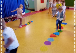 Dzieci pokonują sensoryczną ścieżkę w rytm muzyki