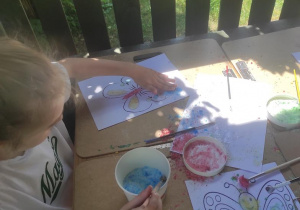 Dzieci podczas malowania motyli.