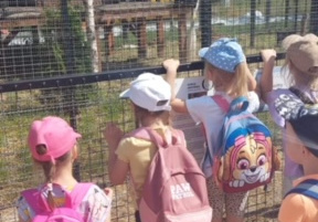 Dzieci przy klatce z małpkami.