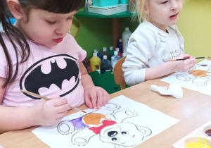 Dzieci wykonują pracę plastyczną z użyciem farb