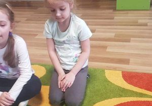 Dzieci układają kompozycje kwiatowe z mozaiki geometrycznej.