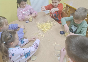 Dzieci wykonują kurczaczki ze słoika.