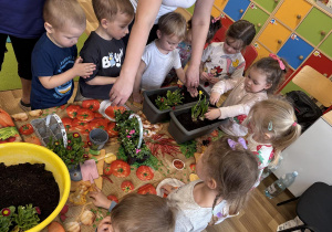 dzieci sadzą kwiatki grupa