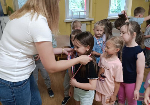 Pani wręcza dzieciom medale.