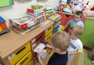 Pawełek wkłada do szufladki upominek dla Lilianki