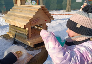 Dzieci dokarmiają ptaki.