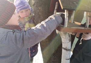 Dzieci dokarmiają ptaki.