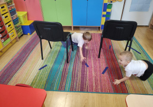 Dzieci wykonują slalom między krzesełkami