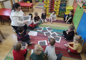 Dzieci oglądają karty przedstawiające złudzenia optyczne