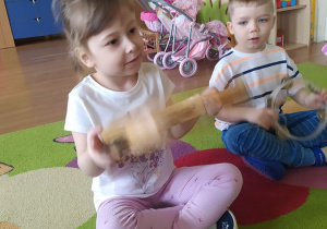 Dzieci tworzą muzykę za pomocą instrumentów - tamburyna i marakasów